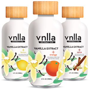 Three vanilla extract bottles with lemon, orange, and spice flavors